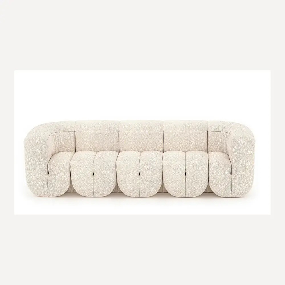Ein geschwungenes, beige Stoffsofa von Desede Switzerland mit eleganter Musterung.