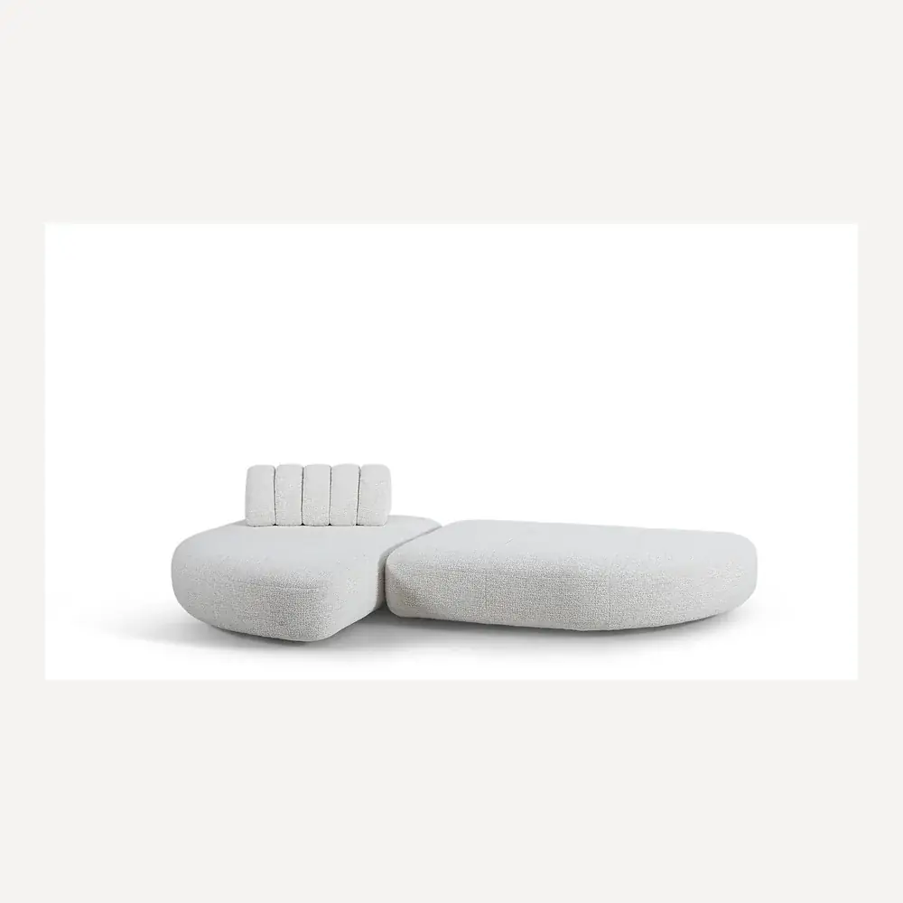 Modulares Stoffsofa in Creme von Desede Switzerland mit gepolsterter Rückenlehne und geschwungenem Design.